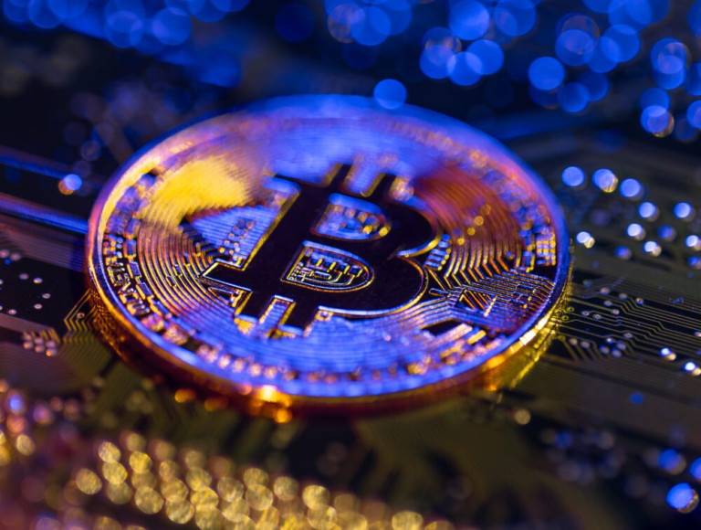 Bitcoin coin close-up on circuit board. Finance concept.