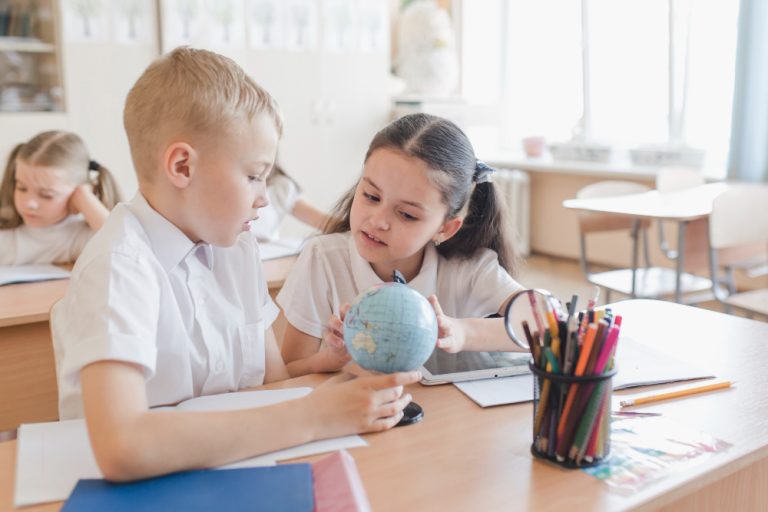kids-examining-globe-lesson-image-by-Freepik